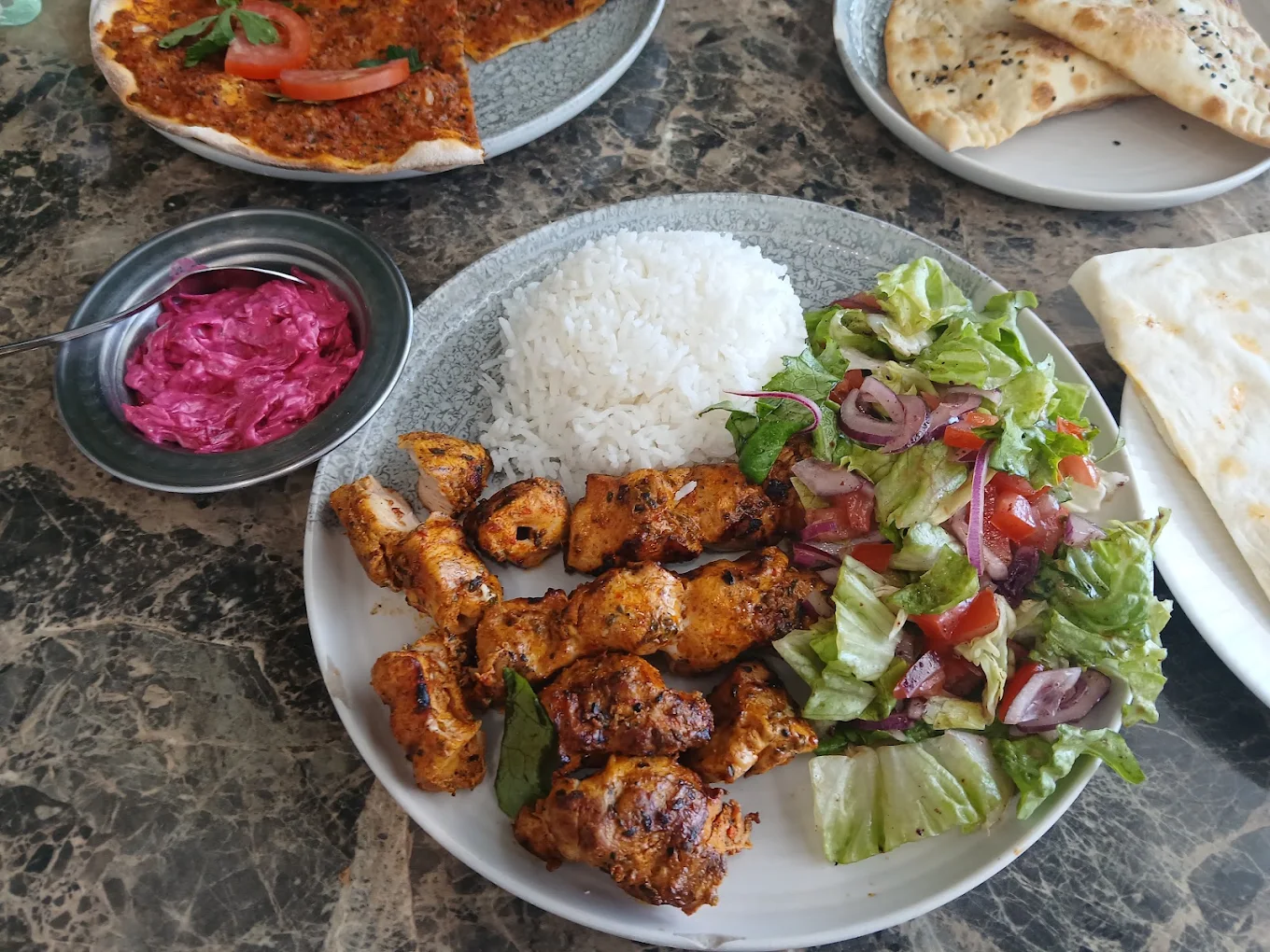 Chicken skewers with rice and salad